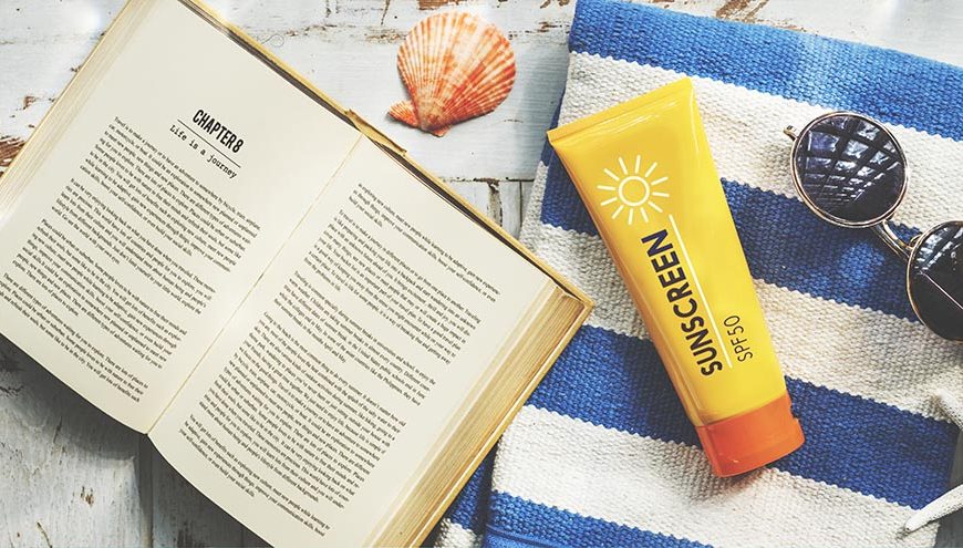 sunscreen sunglasses towel book recess relax concept
